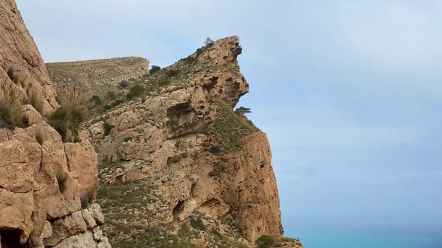 The breathtaking cliffs, adorned with lush greenery, provide stunning views of the vibrant blue ocean below