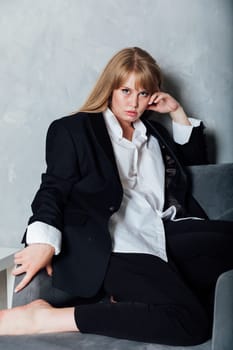 Fashionable Woman in Black Men's Suit Sitting on Chair Portrait