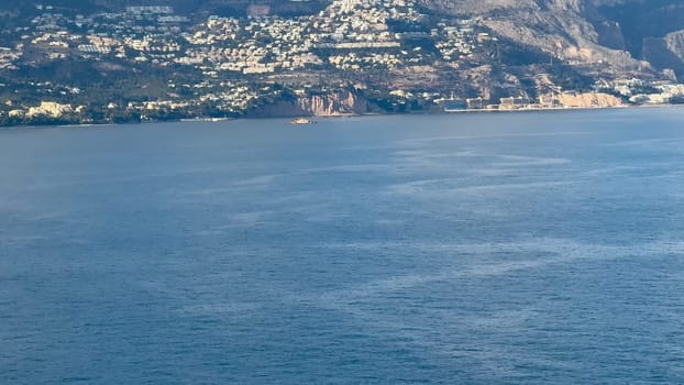 A breathtaking panorama of a coastal landscape featuring serene waters, hills, and picturesque homes.
