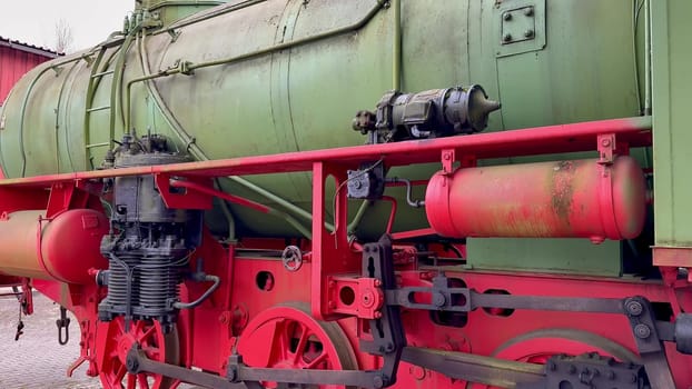 An intricate and detailed view of an old steam locomotive proudly showcasing its vibrant and colorful machinery