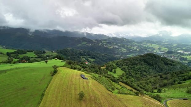 Experience the breathtaking aerial view of stunning landscapes showcasing green hills and valleys beneath cloudy skies