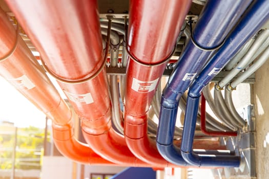 industry large metal pipe clean new hot and cool water from pump  room in the building