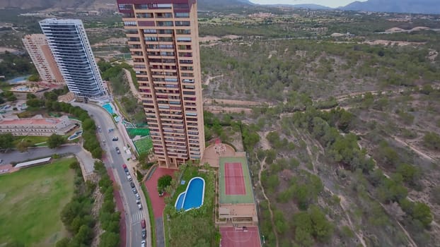 An aerial perspective beautifully showcasing luxury apartments that are surrounded by lush landscapes and scenic hills