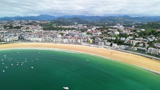A breathtaking aerial view of a vibrant coastal city, showcasing sandy beaches alongside numerous moored boats