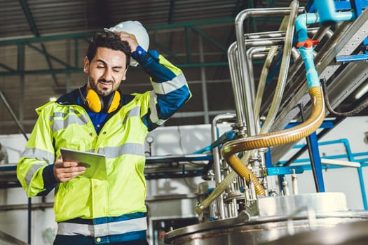 stress problem headache bad face expression hispanic engineer worker working in factory