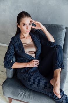 Portrait of a beautiful fashionable woman in a gray business suit