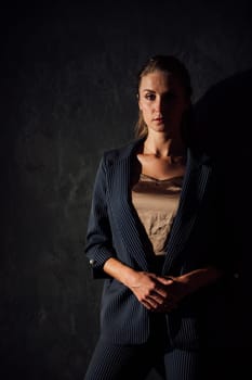 Portrait of a beautiful fashionable woman in a gray business suit
