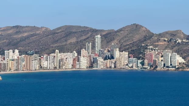 Experience the breathtaking skyline of Benidorm and its stunning coastline, framed by majestic mountains