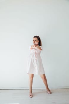 Brunette 40 years old in summer dress dancing to music
