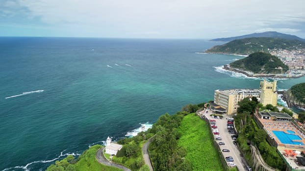 A stunning aerial view of a coastline with vibrant blue waters and lush green foliage surrounding it