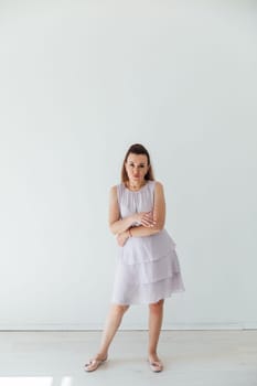 Brunette 40 years old in summer dress dancing to music