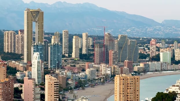 A vibrant coastal city skyline featuring stunning modern buildings alongside a beautiful sandy beach