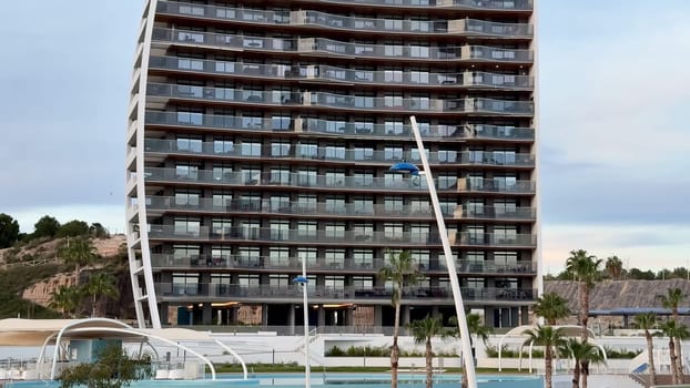 An impressively striking modern building showcasing a distinctive curved facade complemented by elegant balconies