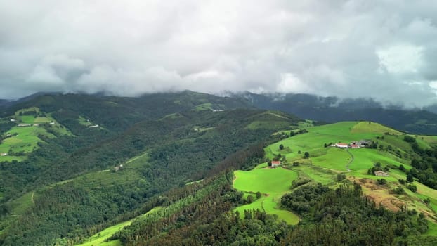 Breathtaking aerial footage showcases vibrant green landscapes and rolling hills beneath an overcast sky setting