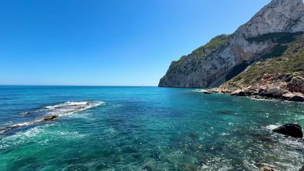 A stunning and breathtaking seascape depicting beautiful turquoise waters along with dramatic high cliffs