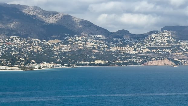 A breathtaking view of the stunning coastline, featuring exceptionally clear blue waters and picturesque green hills