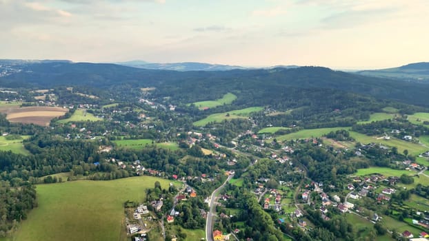 A stunning aerial landscape beautifully showcasing the vibrant green hills along with peaceful villages nearby