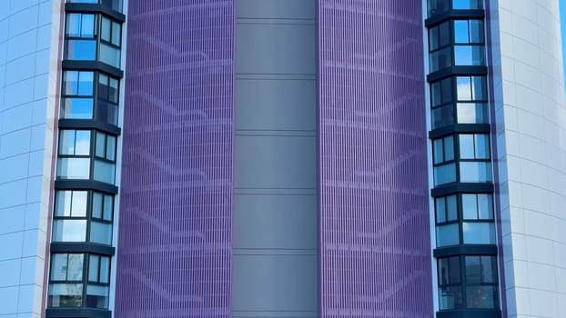 Explore this striking building featuring a distinctive purple facade and contemporary design elements.