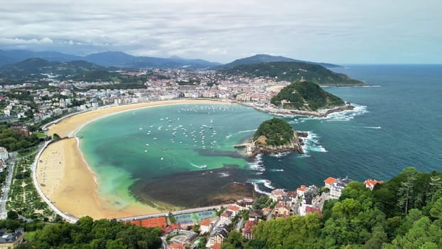 Enjoy breathtaking aerial views of a picturesque bay with boats, beautiful beaches, and lush greenery