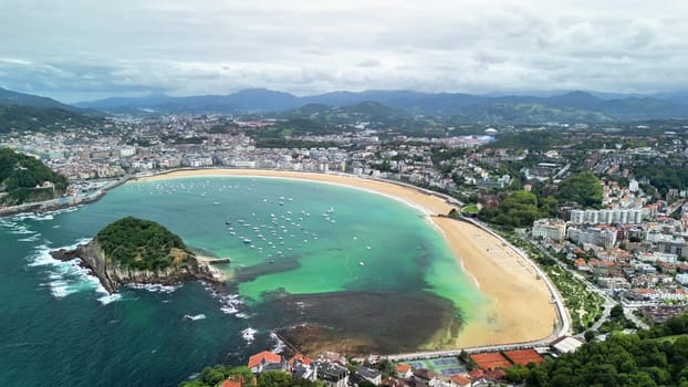 Breathtaking aerial view of a stunningly beautiful beach that is completely surrounded by a vibrant cityscape