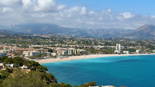 A stunning coastal landscape with turquoise waters, sandy beaches, and majestic mountains surrounding it