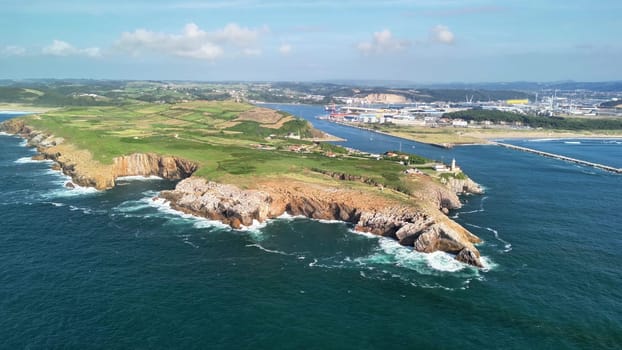 An aerial view captures stunning cliffs, lush greenery, and ocean waves, creating a breathtaking backdrop