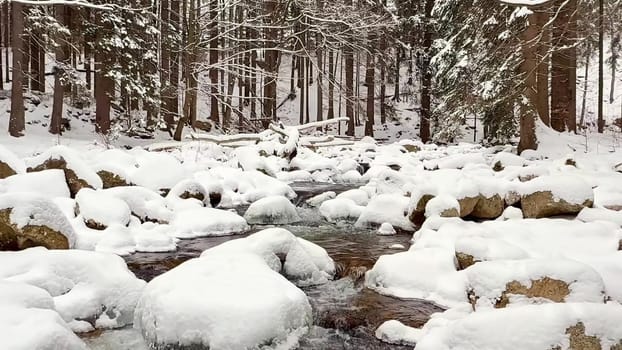 A beautifully peaceful winter scene showcasing a snowcovered river winding its way through a tranquil forest landscape