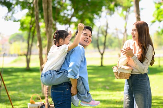 Happy asian family bonding during a camping trip.