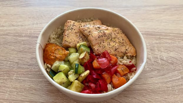 Experience a tasty and nutritious salmon bowl packed with fluffy rice, vibrant fresh vegetables, and a delicious sauce