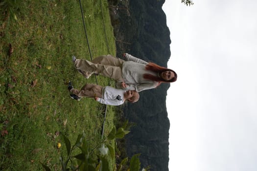Tourists enjoying a peaceful walk in nature, exploring the serene landscape near a majestic mountain