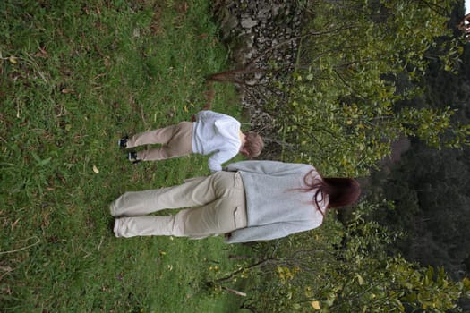 Mother and son enjoying a walk in the countryside, exploring nature and spending quality time together