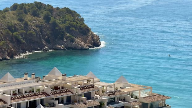 A stunning and picturesque coastal scene showcasing clear blue waters alongside a lush green tropical island