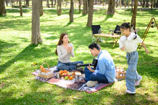 Family having fun at a campsite with tents in the background.