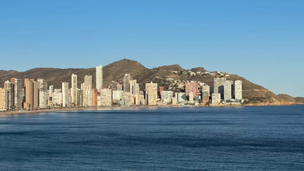 A breathtaking and stunning coastal panorama showcases towering highrises set against a tranquil ocean backdrop