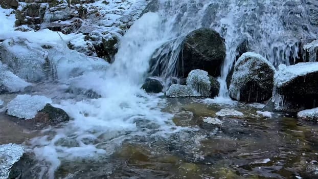 A beautifully picturesque frozen stream gracefully flowing over rocks, capturing the exquisite beauty of winters chill