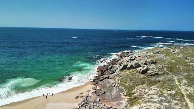 A breathtaking aerial view of a picturesque coastal landscape with rocky shores and clear blue waters