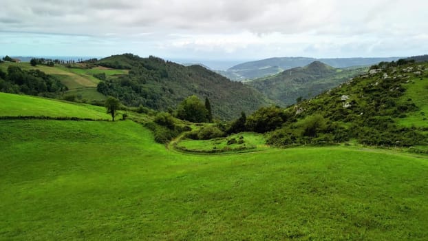 A breathtakingly picturesque view showcases the lush green hills and serene valleys within a tranquil landscape