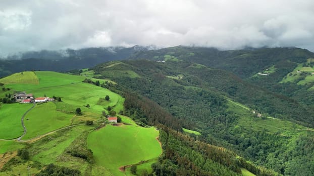 Breathtaking aerial landscape showcasing rolling green hills and scenic farmland under a cloudy sky.