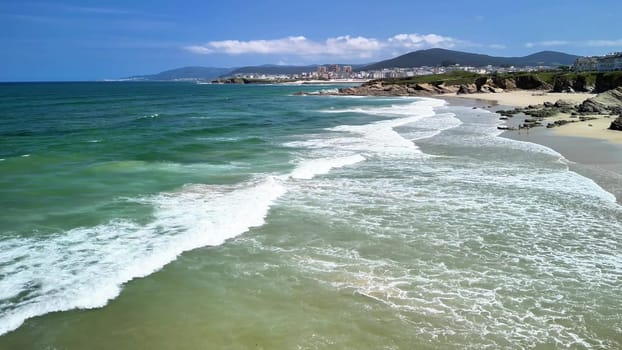 A breathtaking beach scene showcasing the soothing sound of gentle waves rolling in against a beautiful horizon