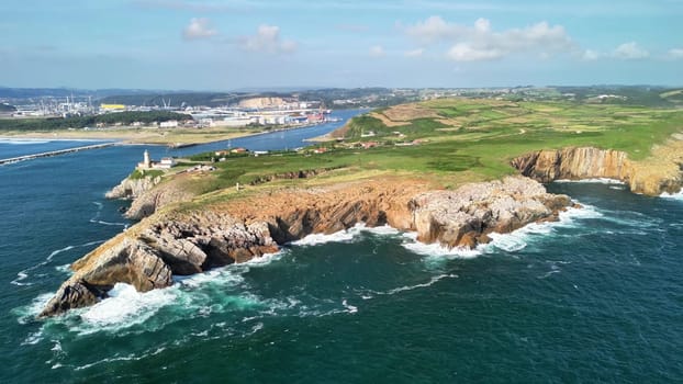A breathtaking aerial view captures dramatic cliffs gracefully meeting the ocean, highlighting natures vibrant beauty