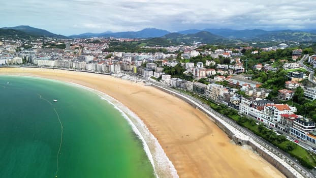 Stunning aerial footage showcases a breathtaking beach beautifully intertwined with a vibrant coastal city