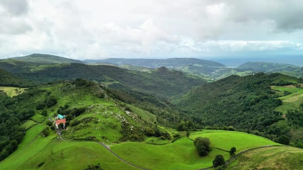 Experience a breathtaking landscape showcasing rolling hills, lush greenery, and serene, expansive skies