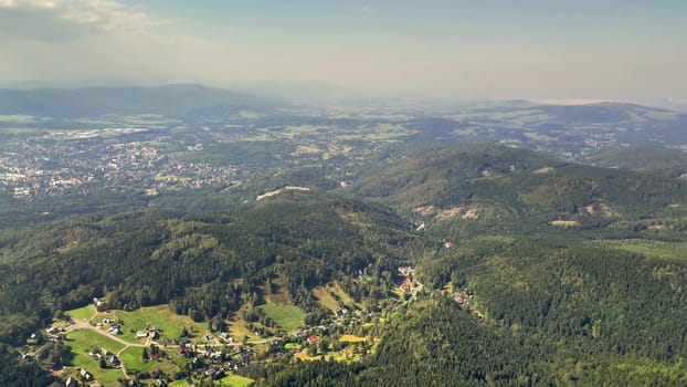 A breathtaking aerial image beautifully showcasing serene valleys along with vibrant greenery surrounding them