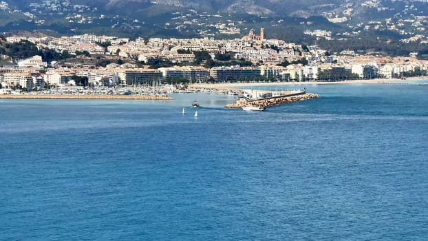 The coastal view showcases tranquil blue waters alongside vibrant and picturesque shoreline scenery