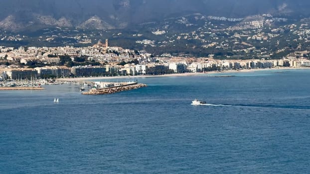 A breathtaking scene of a vibrant coastal city soaking up the beautiful sunlight along the idyllic Mediterranean Sea