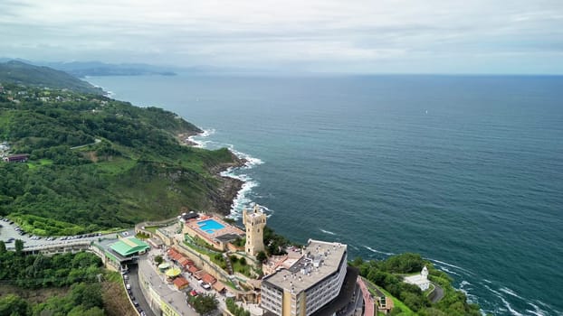 A breathtaking aerial view of a stunning coastal resort surrounded by lush greenery and the vast ocean