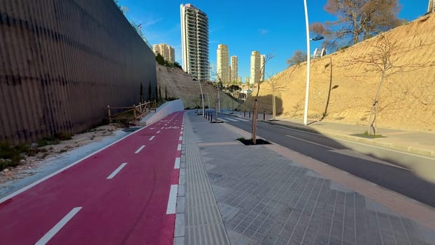 The breathtaking view captures a sleek modern cycling path that is encircled by striking highrise buildings