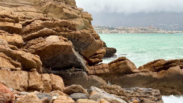 An aweinspiring coastal landscape showcases rugged rocky formations along with powerful crashing waves