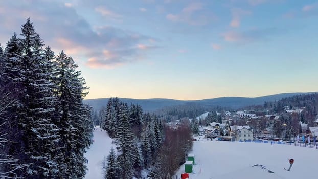 A serene and tranquil winter scene showcasing beautiful snowy trees and a picturesque evening sky at dusk