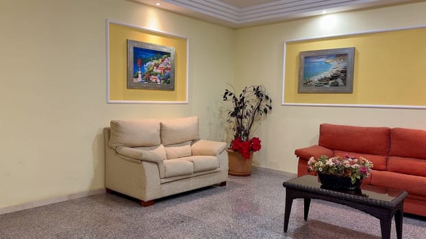 A contemporary and modern living room that features comfortable seating along with vibrant and striking artwork